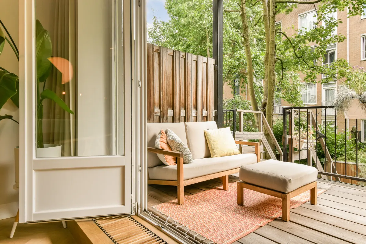 Terrasse en bois dans le Vieil Antibes : balcon en bois aménagé avec canapé et fauteuil